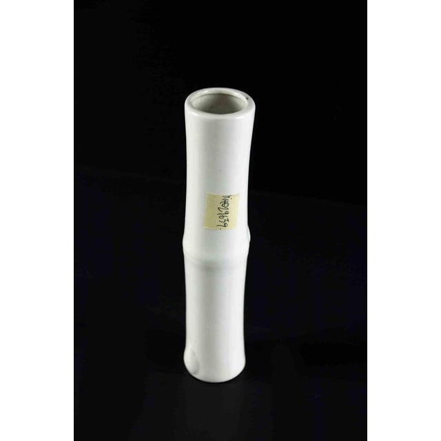 Vintage one flower porcelain vase is an original decorative object realized in the 1970s. A minimal and porcelain flower...