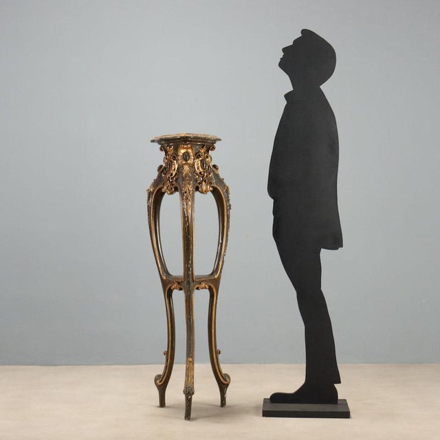 Barocchetto style plant stand crafted from carved, lacquered, and gilded wood, dating back to the early 20th century in...