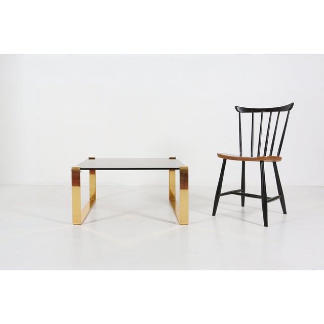 A sophisticated Belgian vintage coffee table from the 1970s, exemplifying the refined glamour of the Mid‑Century Regency...