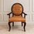 Make a bold statement with this luxurious French Empire style armchair, expertly crafted with rich cognac leather...