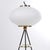 Stilnovo-style opaline glass and brass floor lamp, 1950s. White opaline glass shade, black painted metal frame, and brass...