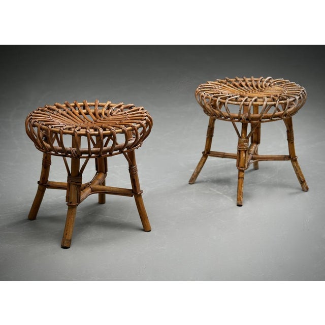 Set of two playful rattan stools in the style of Franco Albini. Nice organic shape, light and easy, works in almost any...