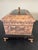 Elegant vintage Maitland-Smith decorative box featuring an intricately carved exterior, dark contrasting trim, ornate gilt...