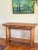 Handcrafted rustic console table constructed from solid wood and finished with a woven rattan top, substantial cylindrical...