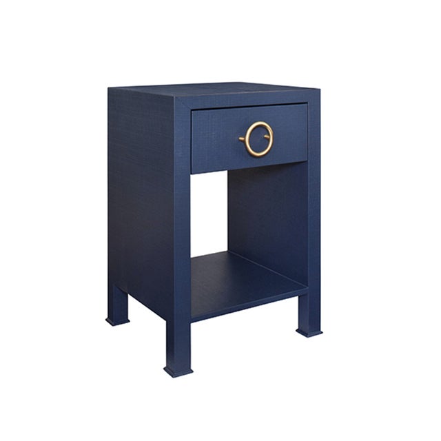 The Malcolm one drawer side table is both sophisticated and functional! Made of navy linen and an antique brass ring draw...