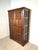 Beautiful antique wardrobe cabinet crafted in solid oak, featuring richly carved decorative panels and a warm, time-worn...