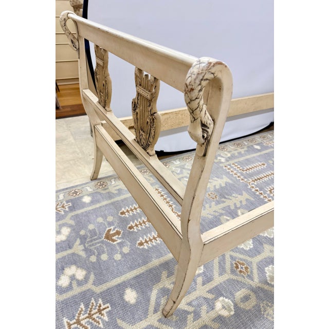 An exquisitely detailed antique French painted twin bed, this piece beautifully marries lyrical carving with romantic...