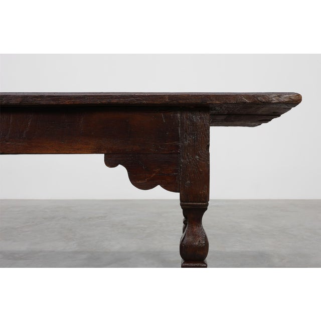 A magnificent 17th‑century Flemish monastery table in solid oak, crafted in Belgium and embodying the rustic strength and...