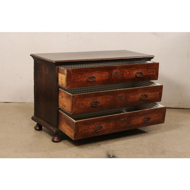 An Italian wooden chest of three drawers from the mid-18th century. This antique chest from Italy has a rectangular-shaped...