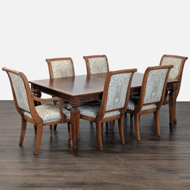 This classic Ethan Allen dining set includes a sturdy wooden table and six matching chairs. The extendable table features...