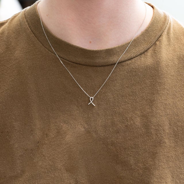 Elegant Ribbon Pendant featuring sparkling natural diamonds, beautifully set in solid 14K white gold for a timeless and...
