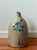 Large 19th century stoneware jug with a single handle, narrow mouth, cobalt blue bird/floral decoration, and an impressed...