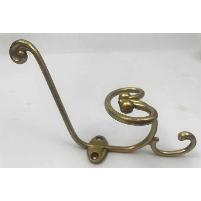 Elevate your space with this exquisite vintage French cast brass triple coat and hat hook from the early 1950s. This...