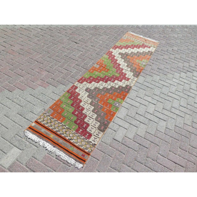 This beautiful, traditional vintage, flatweaved Turkish kilim rug is approximately 60 years old. It is handmade of very...