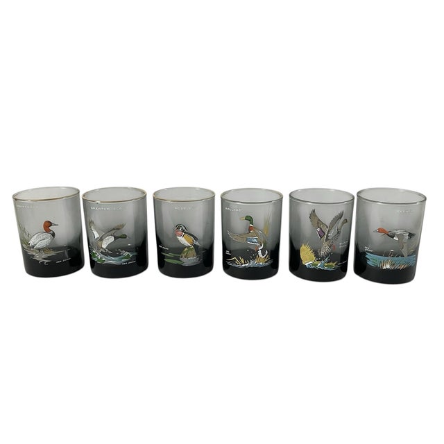 The Ned Smith 22K Gold Rim Waterfowl Double Old-Fashioned Glasses are a set of 6 round glasses signed by Ned Smith. Made...