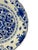 A vintage royal delft wall plate, hand-painted in delft blue with a dense floral centre, a scalloped rim and a decorative...