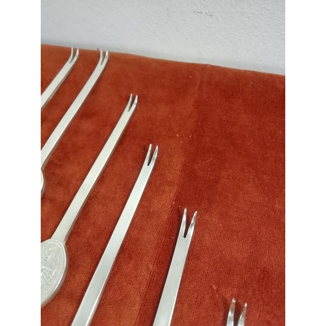 Set of 12 place settings of lobster or lobster forks. Used in the restaurant room of the Achille Lauro ship and other...