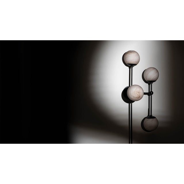 Armstrong 6 captures a sense of movement. Forms connect with spontaneous energy, punctuated by glass spheres. Linear...