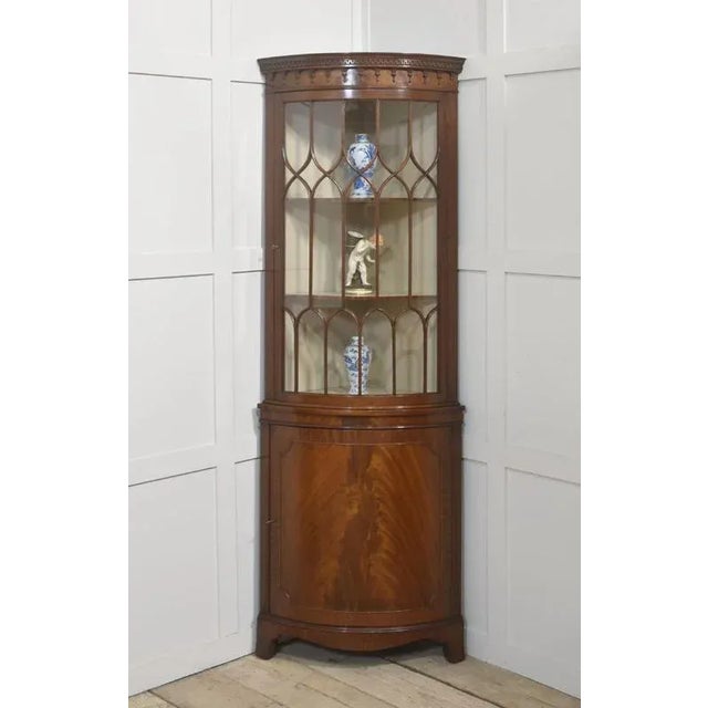 This elegant mahogany corner cabinet is designed in the Georgian style, showcasing fine craftsmanship and timeless appeal....