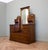 A mahogany dressing chest, circa 1900, with a tall bevelled mirror, carved detailing and decorative brass handles. Seven...
