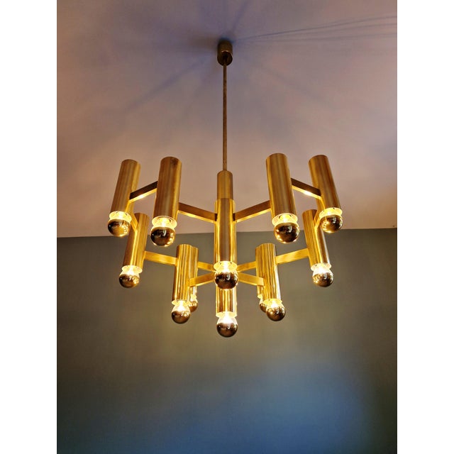 Large brass chandelier, designed by gaetano sciolari for the belgian manufacturer boulanger, 1970s. this geometric...