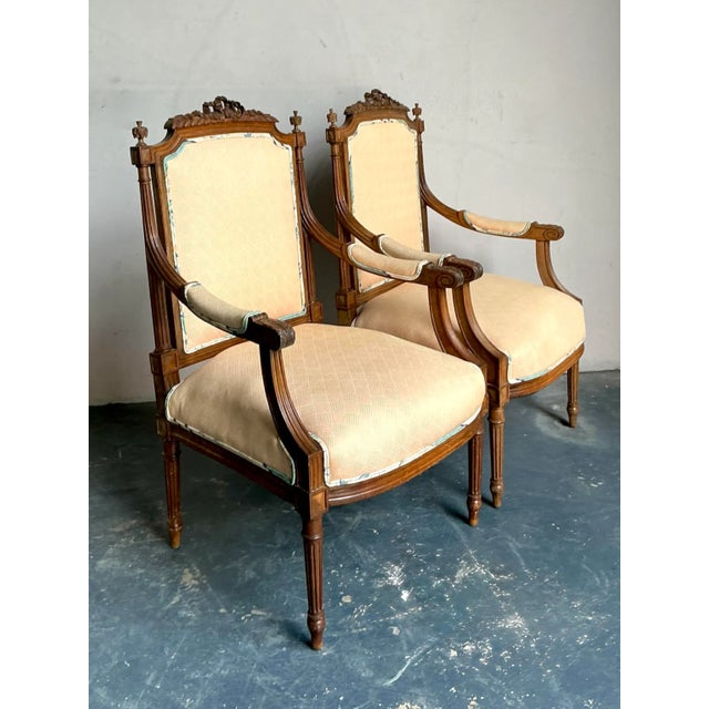 This exquisite pair of armchairs, presented in the elegant Fauteuil style, exemplifies sophisticated Neoclassical and...