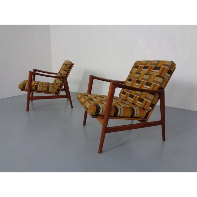 Pair of organic teak armchairs from the 1950s. Design probably Hans Olsen. Pillowcases with original wool fabric. The foam...