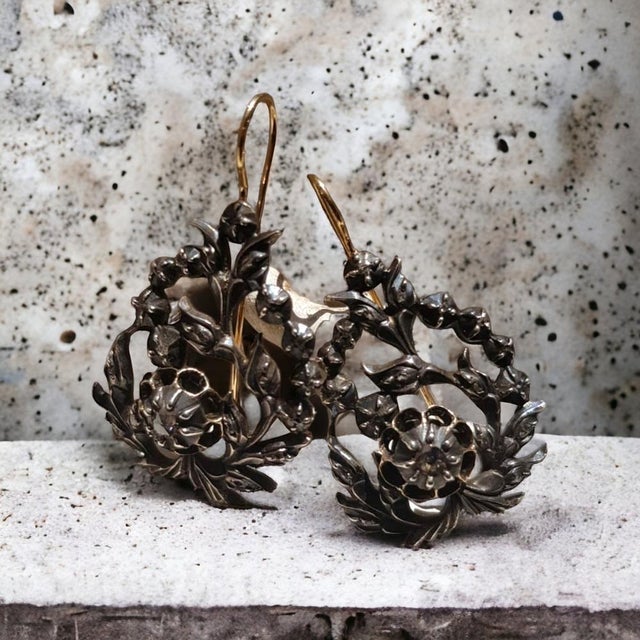 Beautiful pair of antique Georgian earrings with rose cut diamonds set in 18k yellow gold and sterling silver. Dating back...