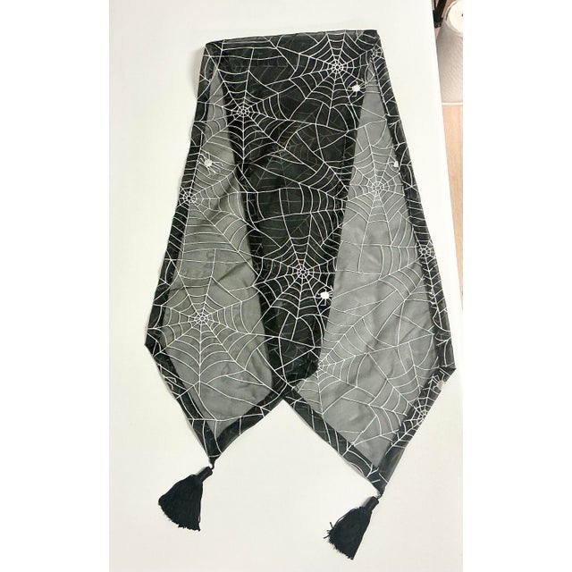 This is from our private collection. We always used this Spider Web Halloween Table Runner on our black console table...