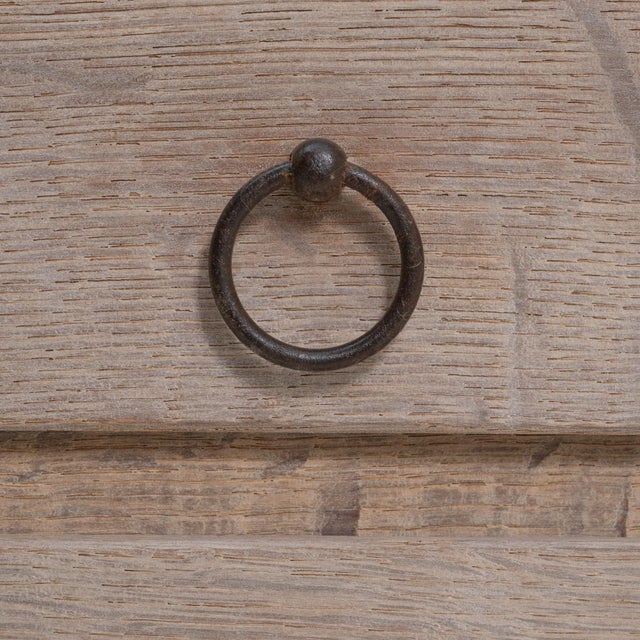 This 20th Century French Neoclassical wooden chest of drawers showcases clean classical lines, tapered legs, and a...