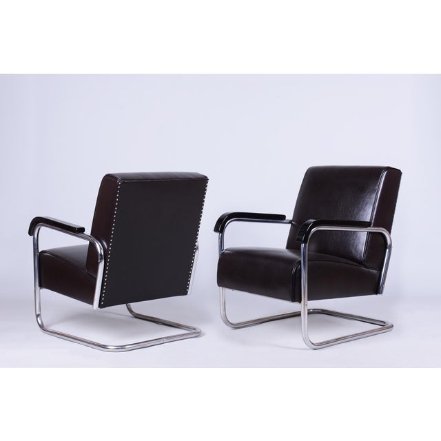 This exclusive pair of sturdy spring armchairs represents the peak of Czechoslovak design from the 1940s and is based on...
