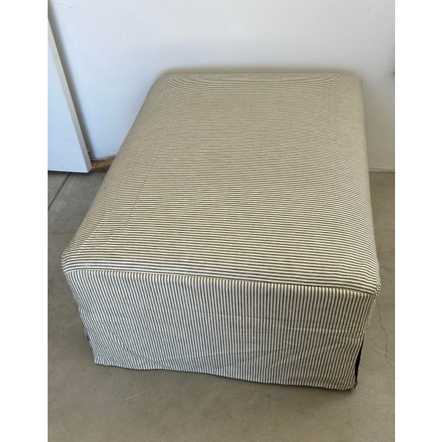 Classic custom upholstered waterfall ottoman featuring clean, tailored lines and a timeless skirted silhouette....