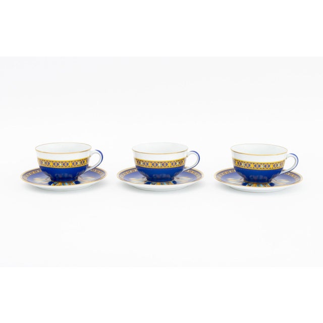 Hermes Paris "Cocarde de Soie" Porcelain Tea Service for Three, with ribbon design and gilt rim, comprising: three (3)...