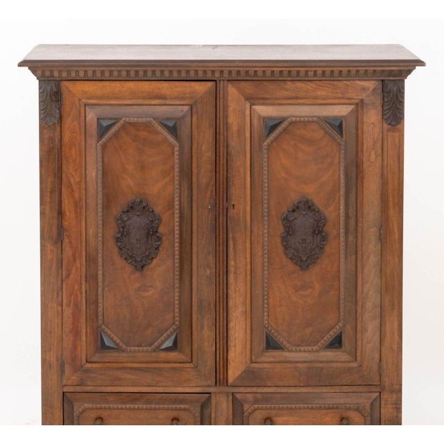 Renaissance Revival Walnut Linen Press, the two doors with carved crest opening to two shelves and hooks above two drawers...