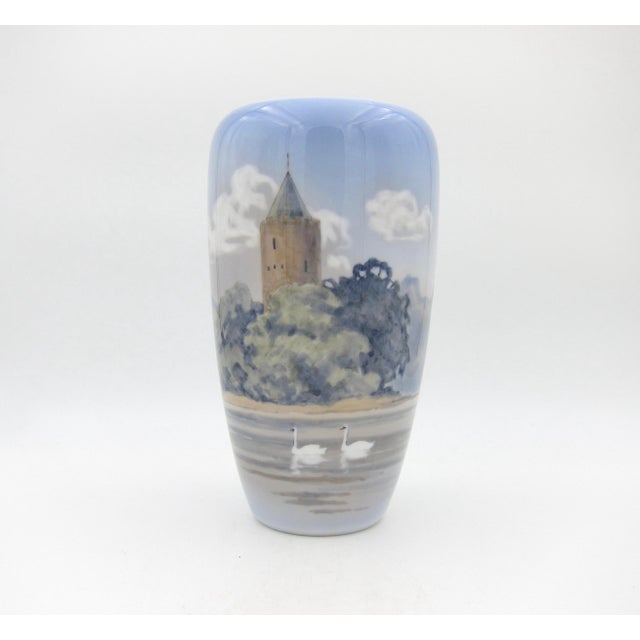 A large porcelain vase from Royal Copenhagen of Denmark, date marked for 1963. The hand-painted decor depicts Denmark's...