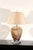 A striking pair of vintage hand-blown glass table lamps featuring sculptural vessel-form bodies in a warm caramel and...
