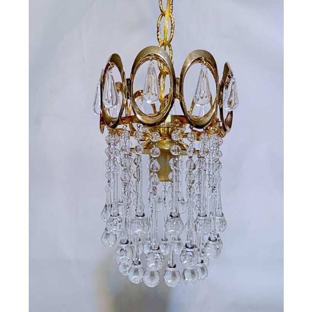 Vintage and restored chandelier with polished gold frame, plain beads and hand blown teardrops. It has 1 Edison base...