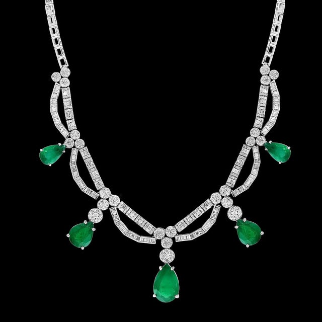 45 ct Zambian Emerald and 12 ct Diamond Necklace and Earring Bridal Suite is a true masterpiece that showcases the...