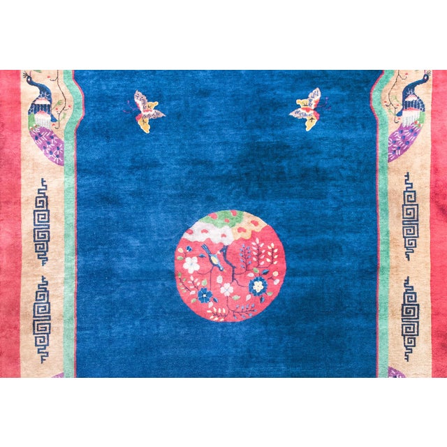 A remarkable early 20th century Chinese Art Deco rug with a central medallion feating a bird sitting in a tree peony and...