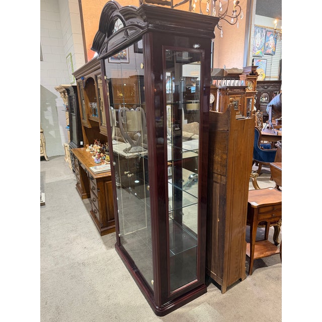 Elevate your display with this refined Howard Miller two-door curio cabinet, a timeless piece that blends classic...