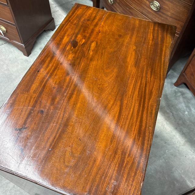 English mahogany Georgian period chest with acorn embellished brass pulls and brushing slide