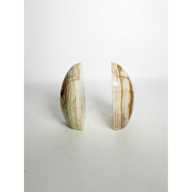 Pair of onyx bookends, France, 20th century. An elegant pair of bookends crafted from polished onyx, highlighting the...