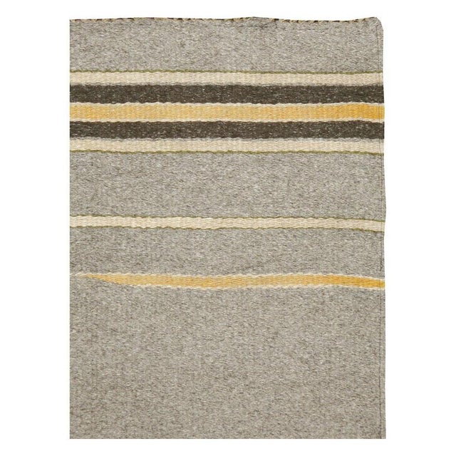 A vintage European flat-weave Kilim throw rug handmade in Poland during the mid-20th century. Measures: 3' 5" x 5' 11"...