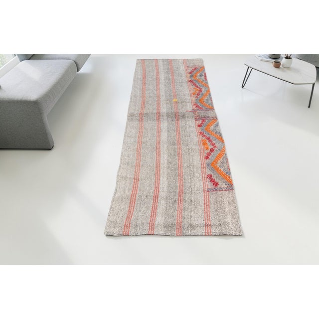 This is a vintage Turkish Oushak rug from the Mid 20th Century. The piece was hand-knotted.