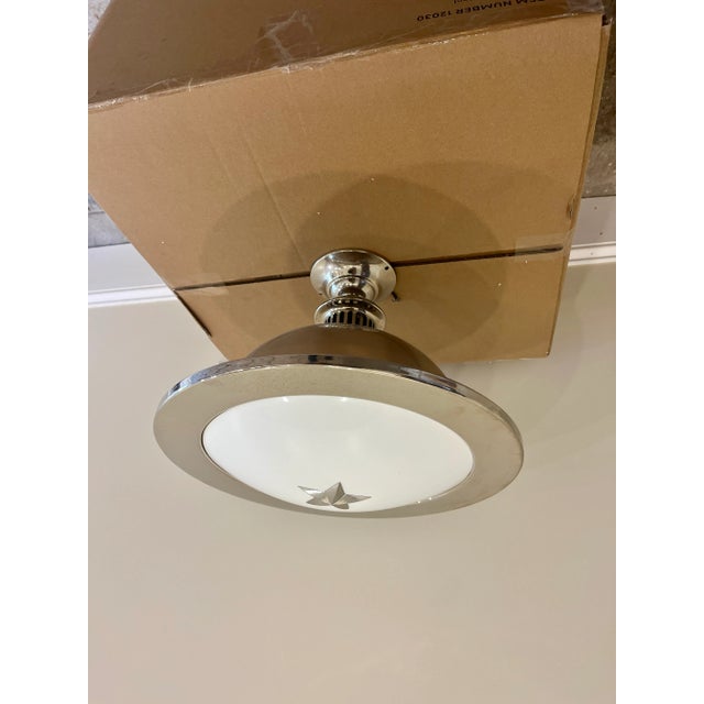 The Remains Lighting Rare Orson Pendant Semi Flush Mount is a modern and stylish lighting fixture that combines stainless...