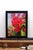 This oil on panel artwork features a vibrant arrangement of blooming roses, their deep red petals contrasting against a...