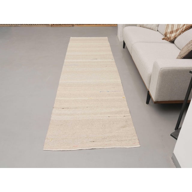 Vintage Hand-Knotted runner rug is a semi-antique vintage area rug. The '70s Eastern region of Anatolia's unique rug is...