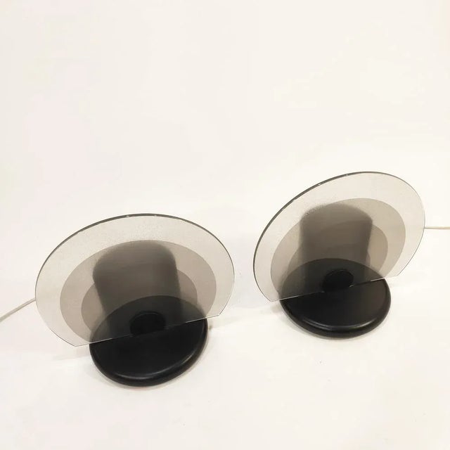 Italian table or desktop lamp couple in Bruno Gecchelin's style, 80s. Made of perforated metal lacquered in black and...