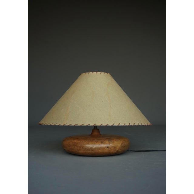 Stylish French table lamp from the 1950s. It has a turned solid wood base with original brass fitting (bayonet fitting)...