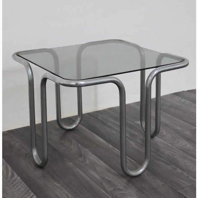 Ezio didone coffee table from the 1970s. Wonderful coffee table made entirely of tubular chromed steel, with a smoked...
